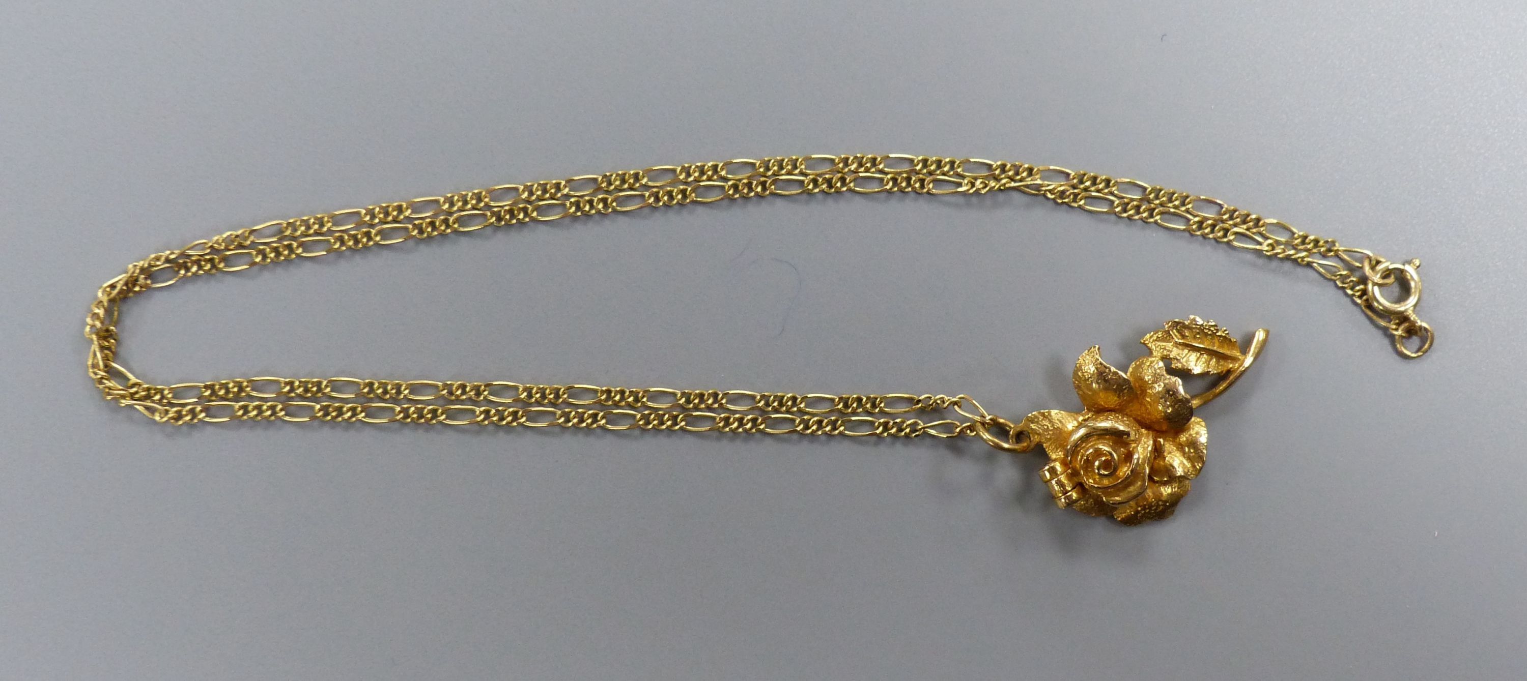A modern 9ct gold rose pendant, 30mm, on a 9ct gold chain, 43cm,